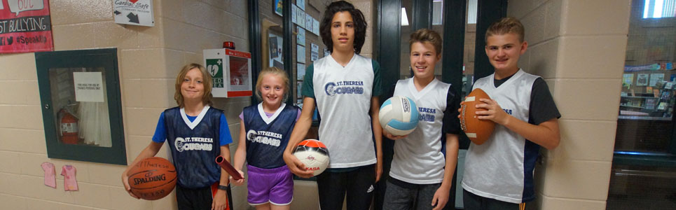 Four St. Theresa Catholic School athletes wearing sports uniforms.
